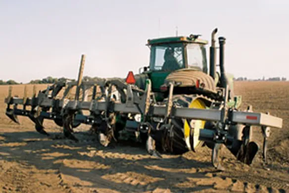 Wilcox 3-point mount rip-lister attached to tractor, performing deep tillage and furrow creation for precision row crop farming.