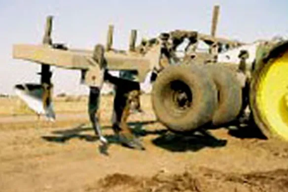 Close-up of Wilcox rip-lister showing shanks and rear tires, engineered for durable in-row soil ripping and moisture management.