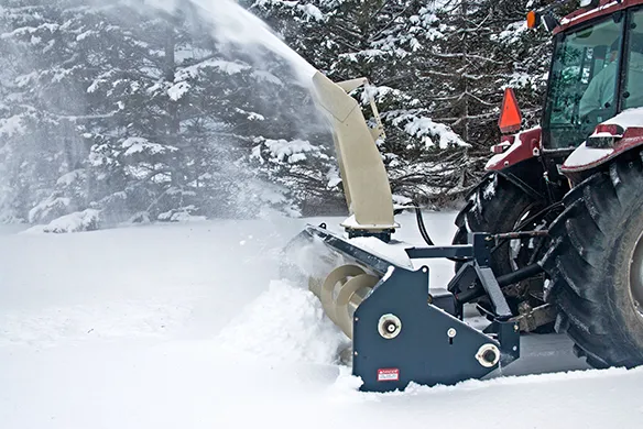 Farm King Allied snowblower clearing deep snow with consistent throwing performance behind a tractor