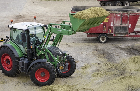 Fendt 500 Vario tractor with loader bucket full of hay.