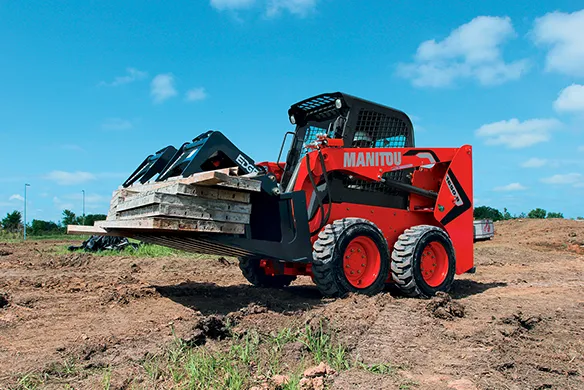 Manitou compact loader transporting palletized materials for jobsite and property material handling