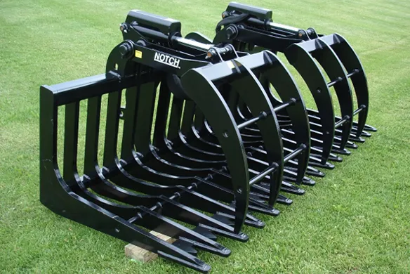 Notch MFG industrial root grapple bucket on display on a green grass lawn.