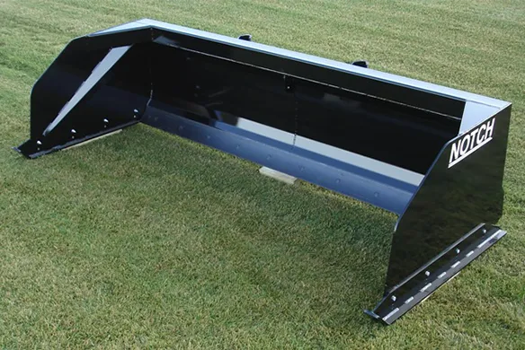 A black, Notch snow pusher on display on a green, grass field.