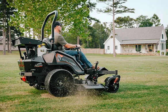 Spartan KGZ-XD zero-turn mower operating on open grass, delivering powerful traction and smooth cutting performance