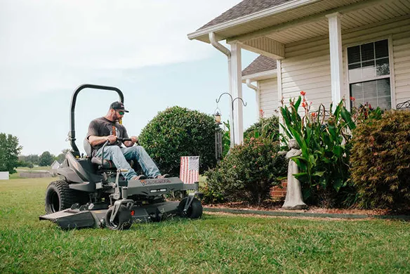 Homeowner operating a Spartan RT-PRO zero-turn mower for powerful, controlled mowing on a residential property