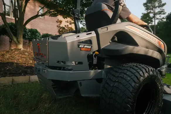 Rear quarter view of a Spartan RT-PRO zero-turn mower highlighting rugged frame design and rear traction tires