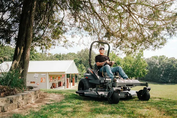 Spartan RZ-XD zero-turn mower cutting grass efficiently on a residential lawn with smooth handling and control