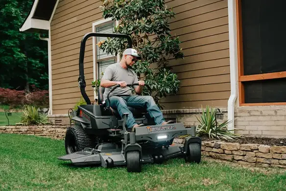 Homeowner operating a Spartan Defender zero-turn mower for smooth, controlled residential lawn mowing