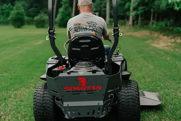 Rear view of a Spartan Defender zero-turn mower showing wide rear tires and durable construction for residential mowing