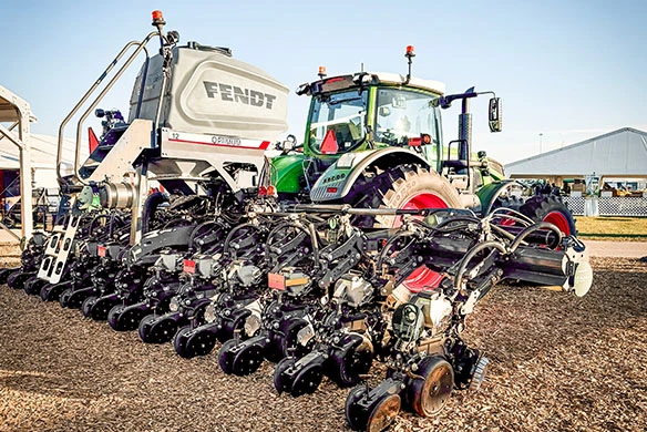 Fendt tractor with Fendt Optimum planter parked in a field.