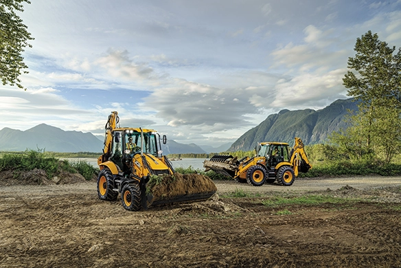 Two JCB 3CX backhoe loaders parked on earthmoving operations in a rural environment