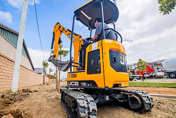 Rear view of JCB 18Z-1 mini excavator showing compact tracked design for tight access jobs
