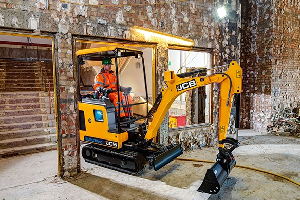 JCB 19C-1E electric mini excavator operating indoors during building renovation