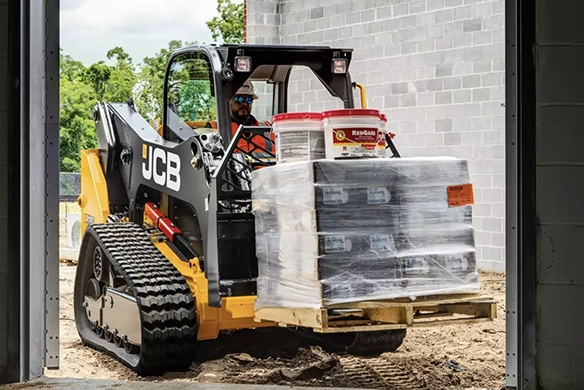 JCB 215T compact track loader transporting materials through a building access opening