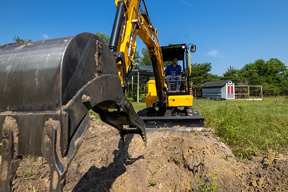 JCB 35Z-1 mini excavator digging a trench in open ground during light construction work