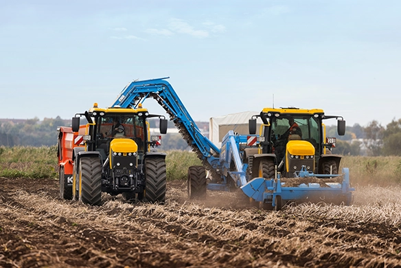 Two JCB 4000 Series agricultural tractors working in tandem with tillage equipment, built for large-scale farming and high productivity