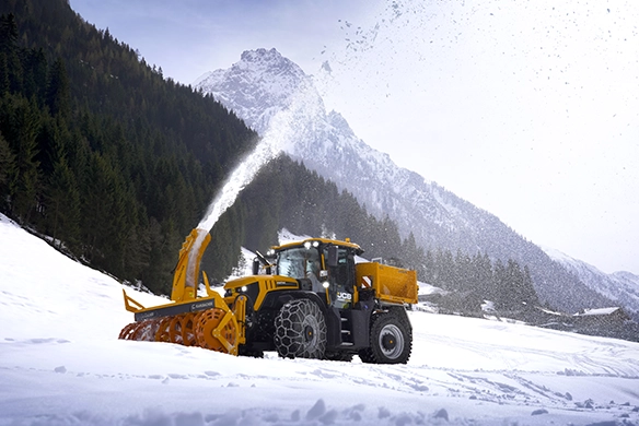JCB 4000 Series ag tractor equipped with a snow blower attachment, delivering year-round versatility and winter operation capability