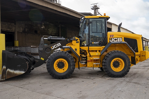 Side view of JCB 437 wheel loader with bucket attachment at an industrial worksite