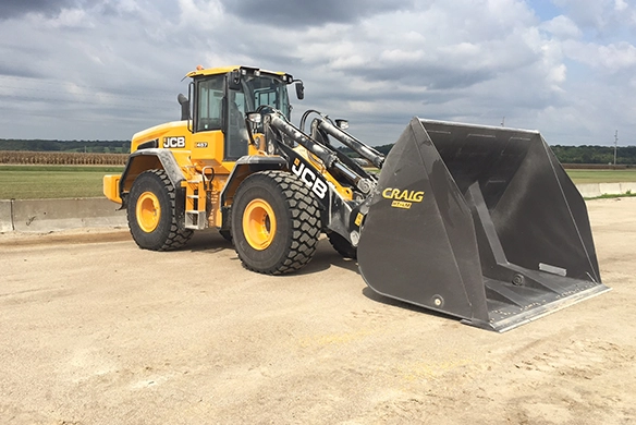 JCB 457S wheel loader fitted with high-capacity bucket for bulk material handling at an industrial site