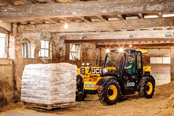 JCB 525-60 telescopic handler transporting materials in a farm building