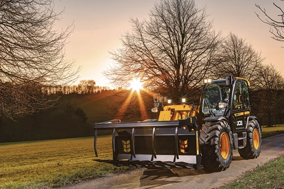 JCB 538-60 Agri with silage grab traveling along a farm lane