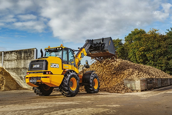 JCB TM420 telescopic wheel loader loading bulk root crop material at an agricultural storage site