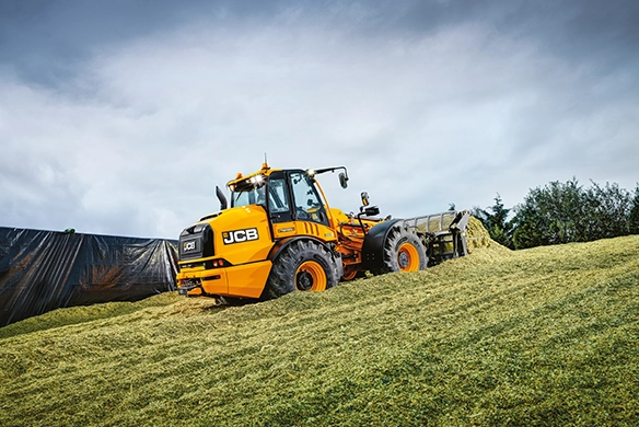 JCB TM420 telescopic wheel loader working on a silage clamp during agricultural material handling