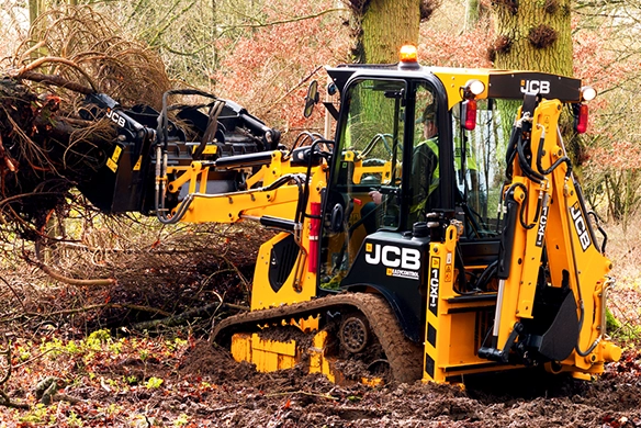 JCB 1CXT compact track backhoe loader handling vegetation during woodland clearance