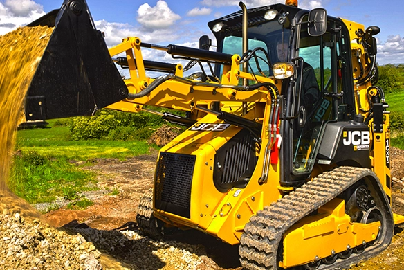 JCB 1CXT compact track backhoe loader loading material with front bucket attachment