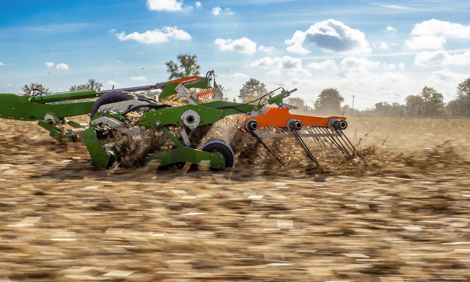 Closeup of an in motion TopCut tillage equipment in a field.