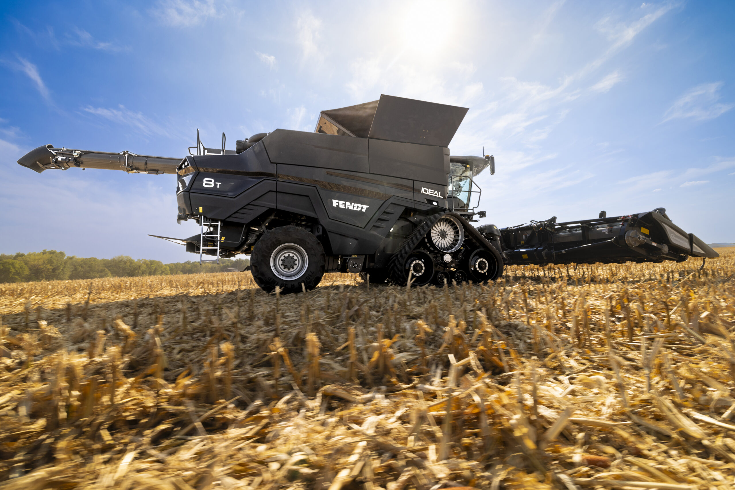 Side view of a Fendt IDEAL combine driving in a field