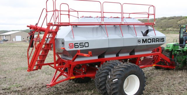 Morris 9 series air cart being pulled over dirt