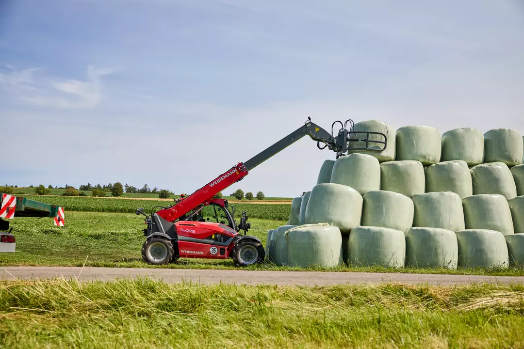Weideman telehandler reaching for bales